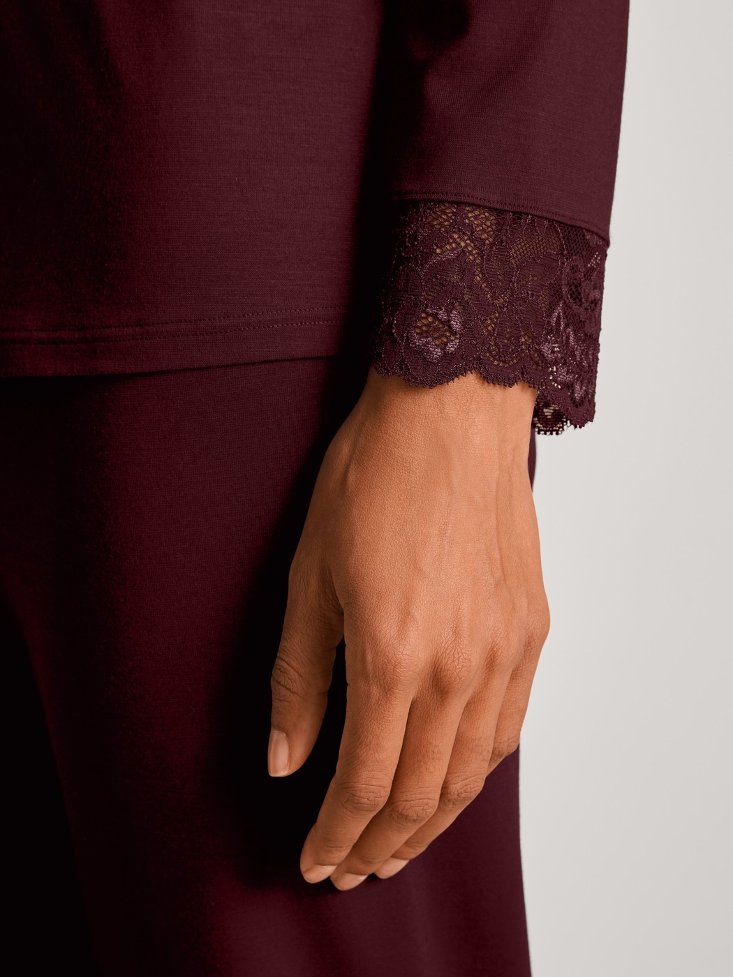 Women model is wearing Pyjamas, long made of Modal in Red, Lace from the Season Special series by CALIDA, Detail
