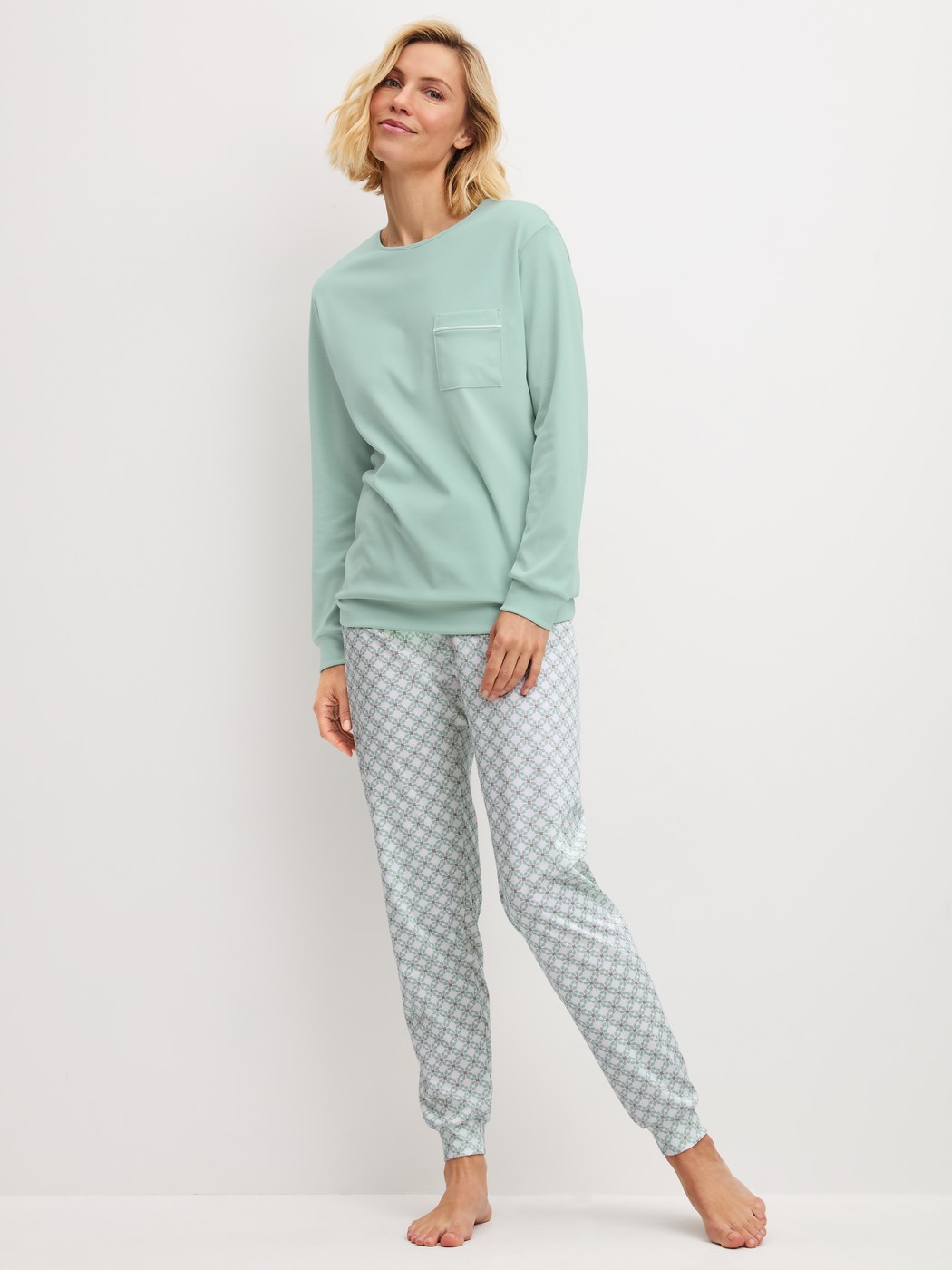 Women model is wearing Pyjama with cuff made of 100% Cotton in Turquoise, Patterned from the Sweet Dreams series by CALIDA, Front view