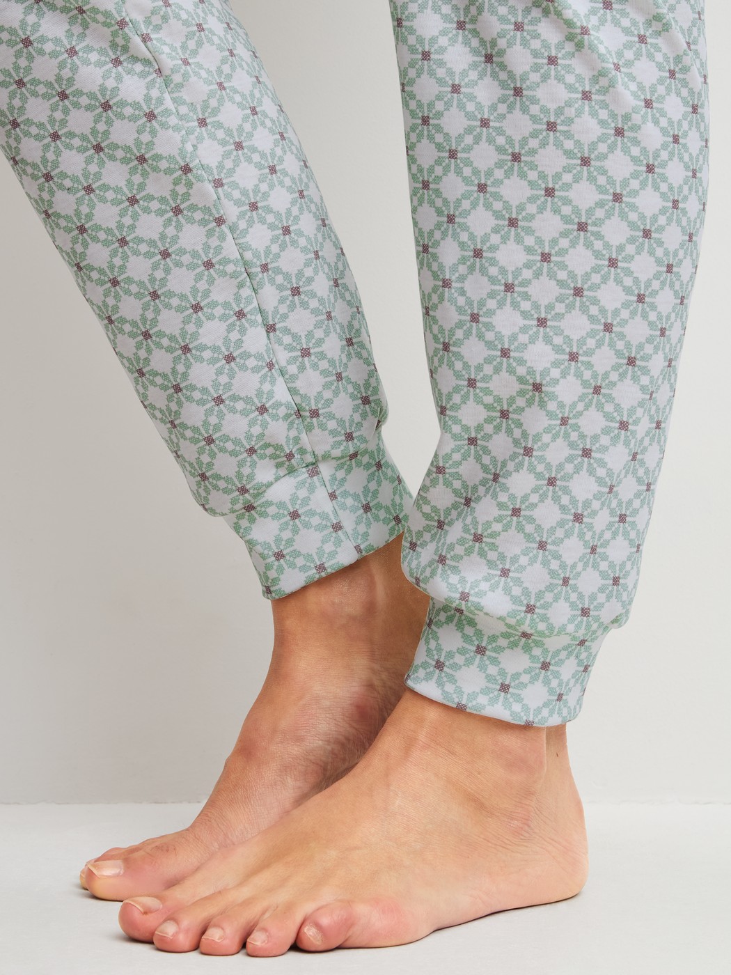 Women model is wearing Pyjama with cuff made of 100% Cotton in Turquoise, Patterned from the Sweet Dreams series by CALIDA, Detail
