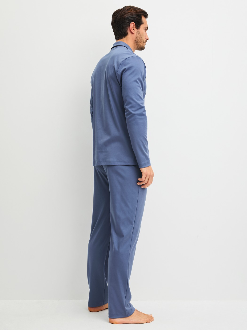 Men model is wearing Pyjamas with buttons made of 100% Cotton in Blue, Unicoloured from the Relax Choice 1 series by CALIDA, Back view