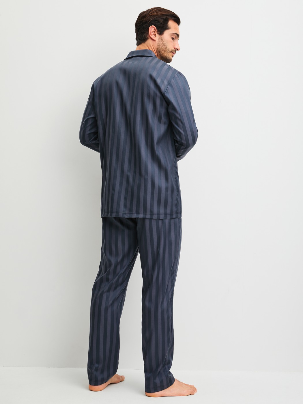 Men model is wearing Pyjamas, long made of Lyocell in Grey, Striped from the Relax Lux series by CALIDA, Back view