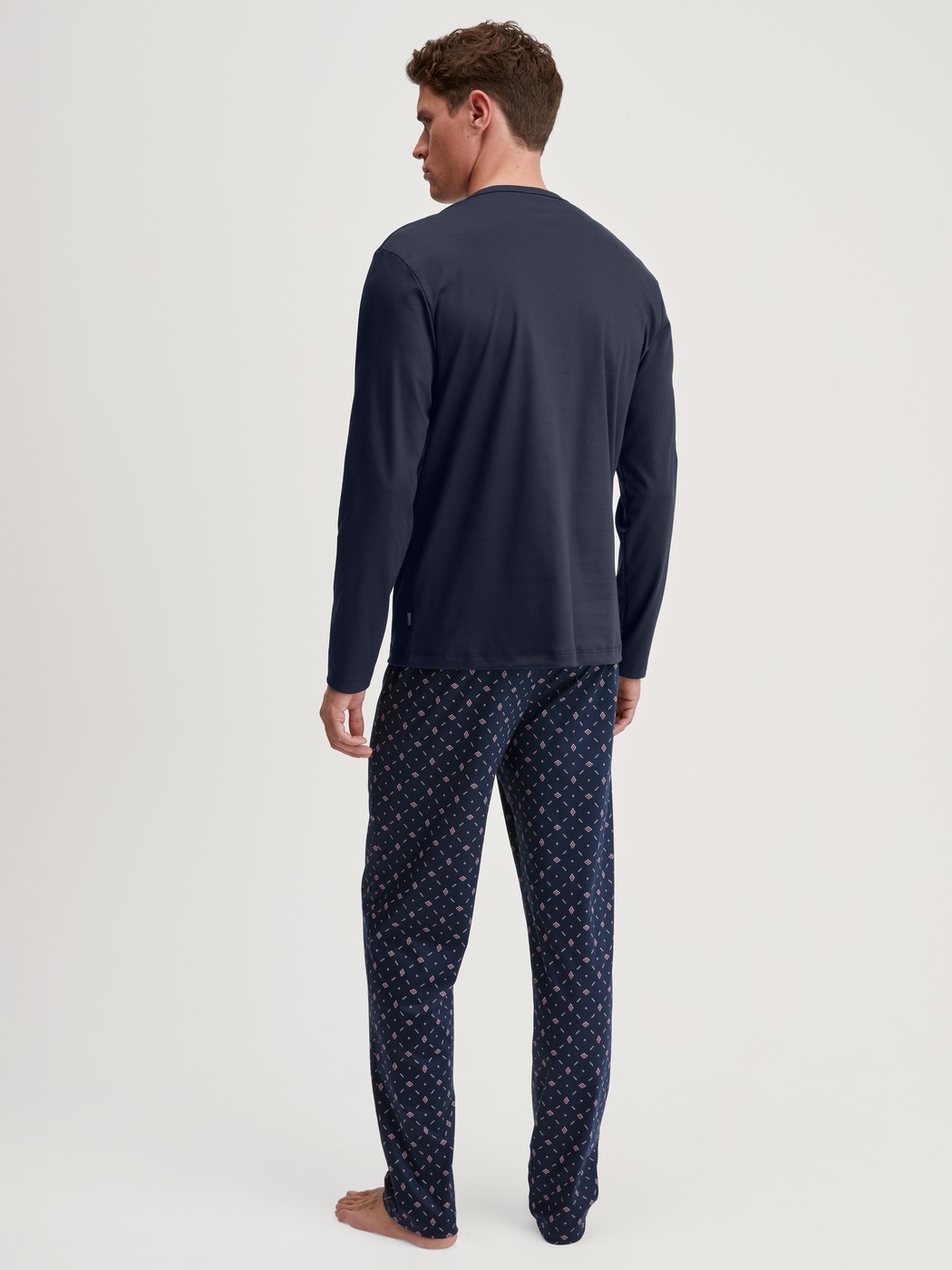 Men model is wearing Pyjamas, long made of 100% Cotton in Blue, Patterned from the Relax Selected 4 series by CALIDA, Back view
