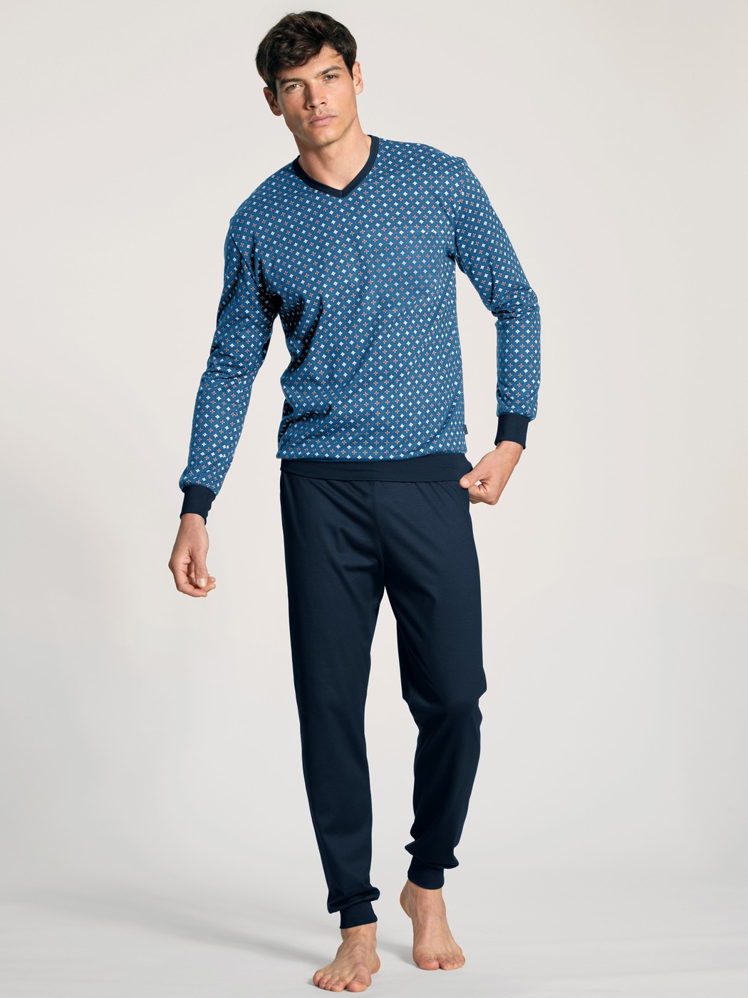 Men model is wearing Pyjama with cuff made of 100% Cotton in Blue, Patterned from the Nightwear Xtra series by CALIDA, Front view