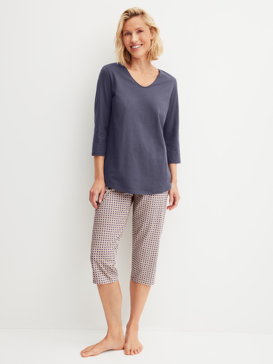 Damen-Model trägt Capri-Pyjama aus 100% Baumwolle in Blau, Gemustert aus Serie Graphic Nights von CALIDA, Vorderansicht