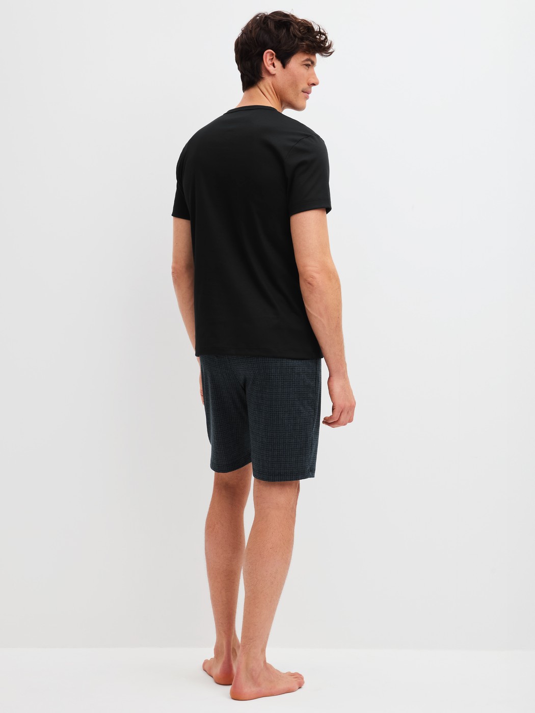 Men model is wearing Short pyjamas made of 100% Cotton in Black, Patterned from the Relax Streamline 2 series by CALIDA, Back view