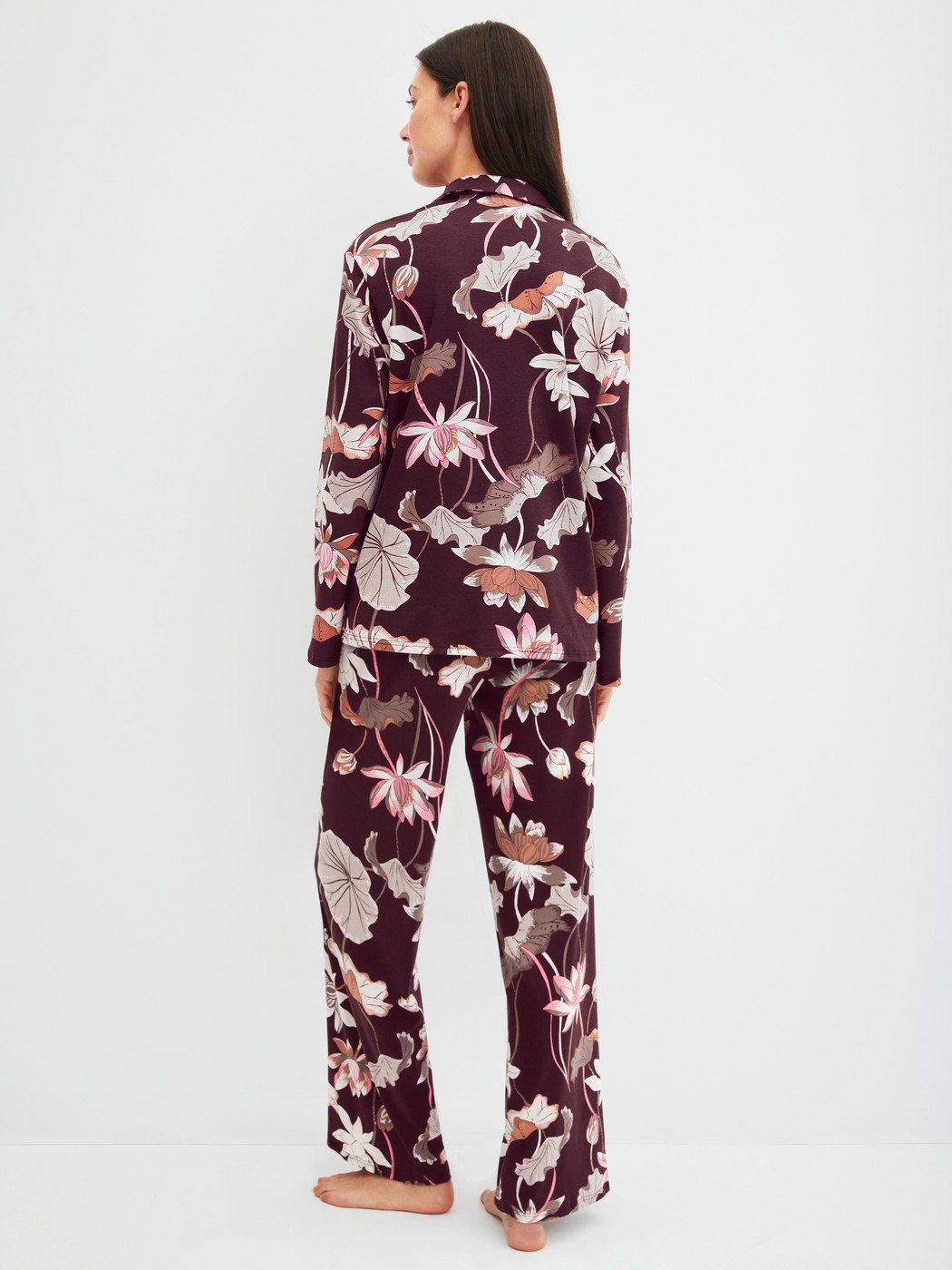 Women model is wearing Button-Up Pyjama made of 100% Cotton in Red, Floral from the Season Special series by CALIDA, Back view