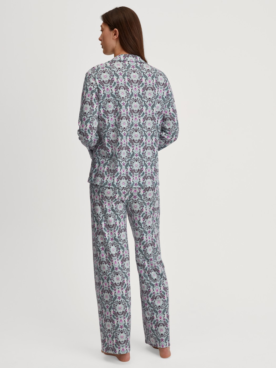 Women model is wearing Button-Up Pyjama made of 100% Cotton in Blue, Patterned from the Autumn Dreams series by CALIDA, Back view