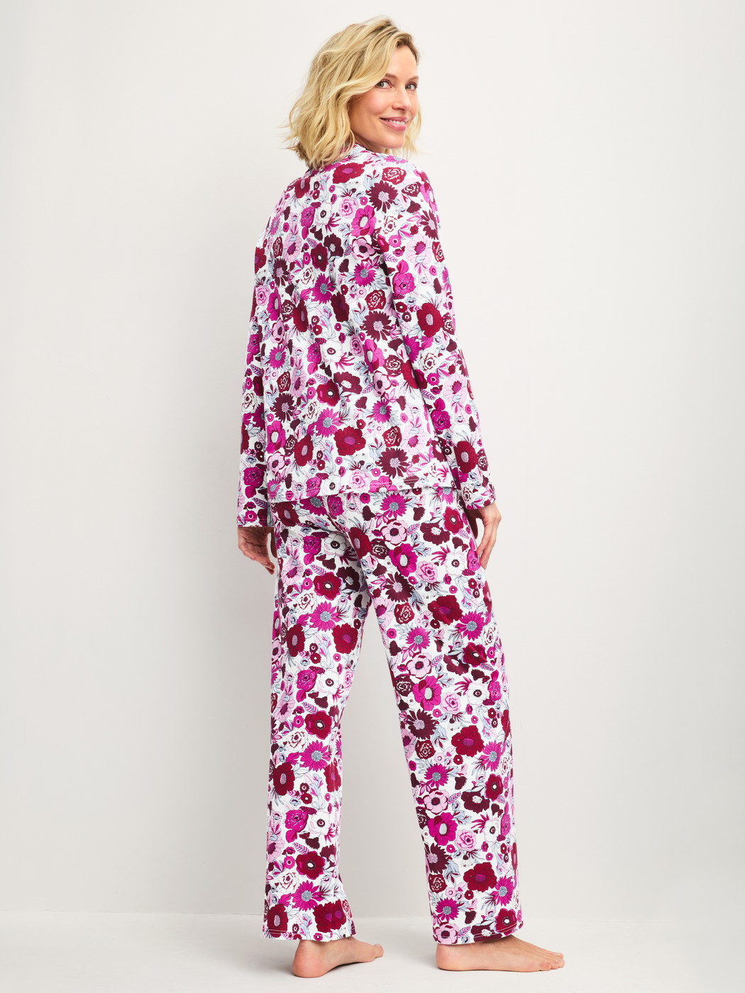 Women model is wearing Button-Up Pyjama made of 100% Cotton in Red, Floral from the Season Special series by CALIDA, Back view