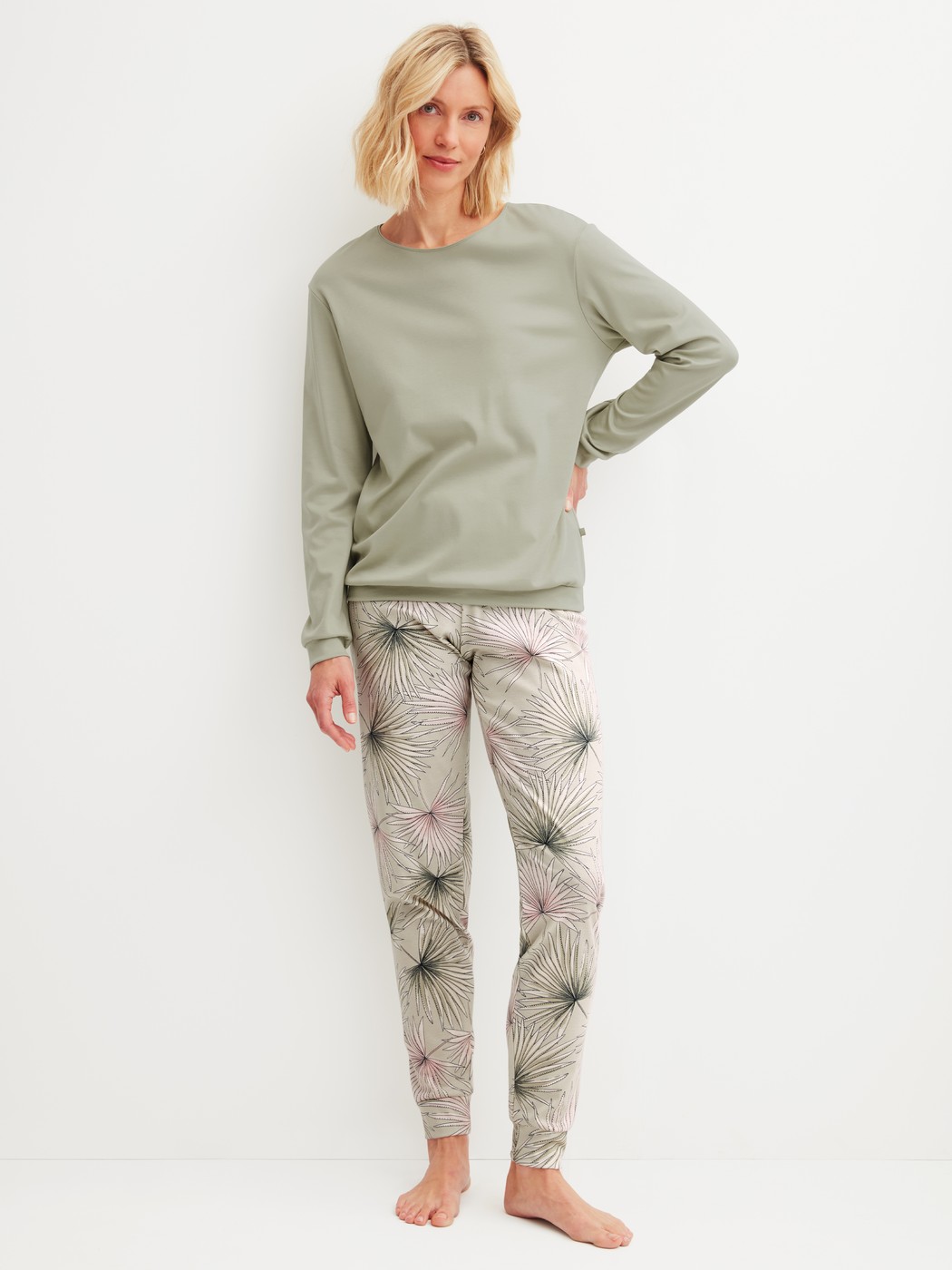 Women model is wearing Pyjama with cuff made of 100% Cotton in Green, Floral from the Leaf Dreams series by CALIDA, Front view