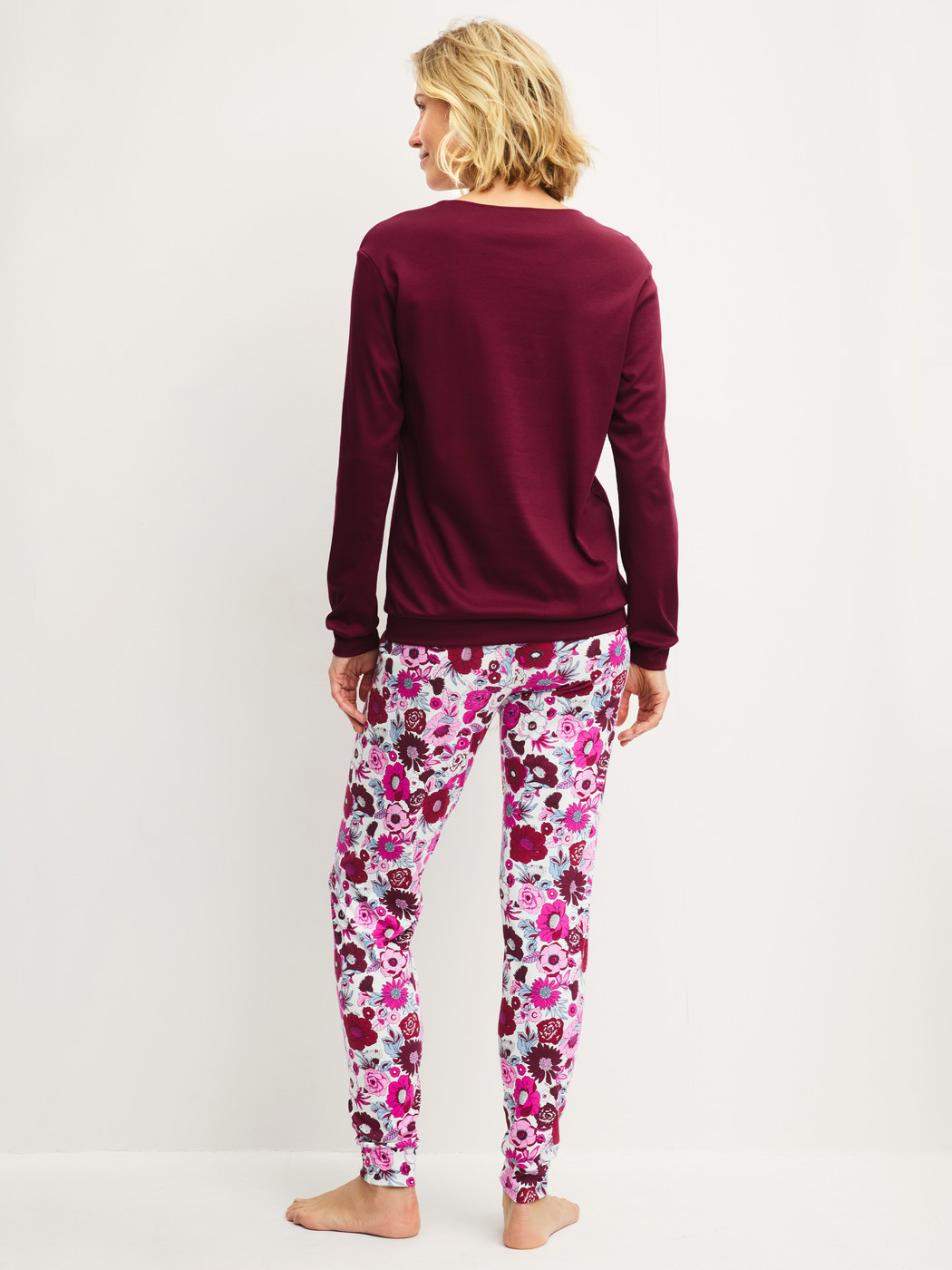 Women model is wearing Pyjama with cuff made of Swiss+Cotton in Red, Floral from the Season Special series by CALIDA, Back view