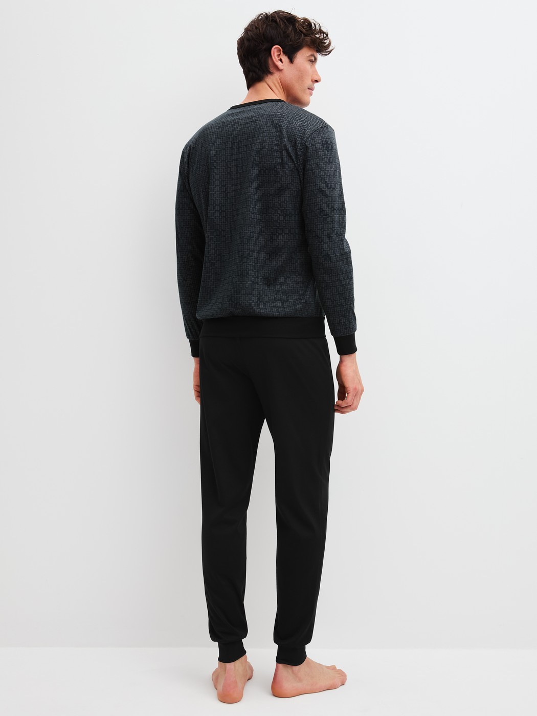 Men model is wearing Pyjama with cuff made of 100% Cotton in Black, Patterned from the Relax Streamline 2 series by CALIDA, Back view