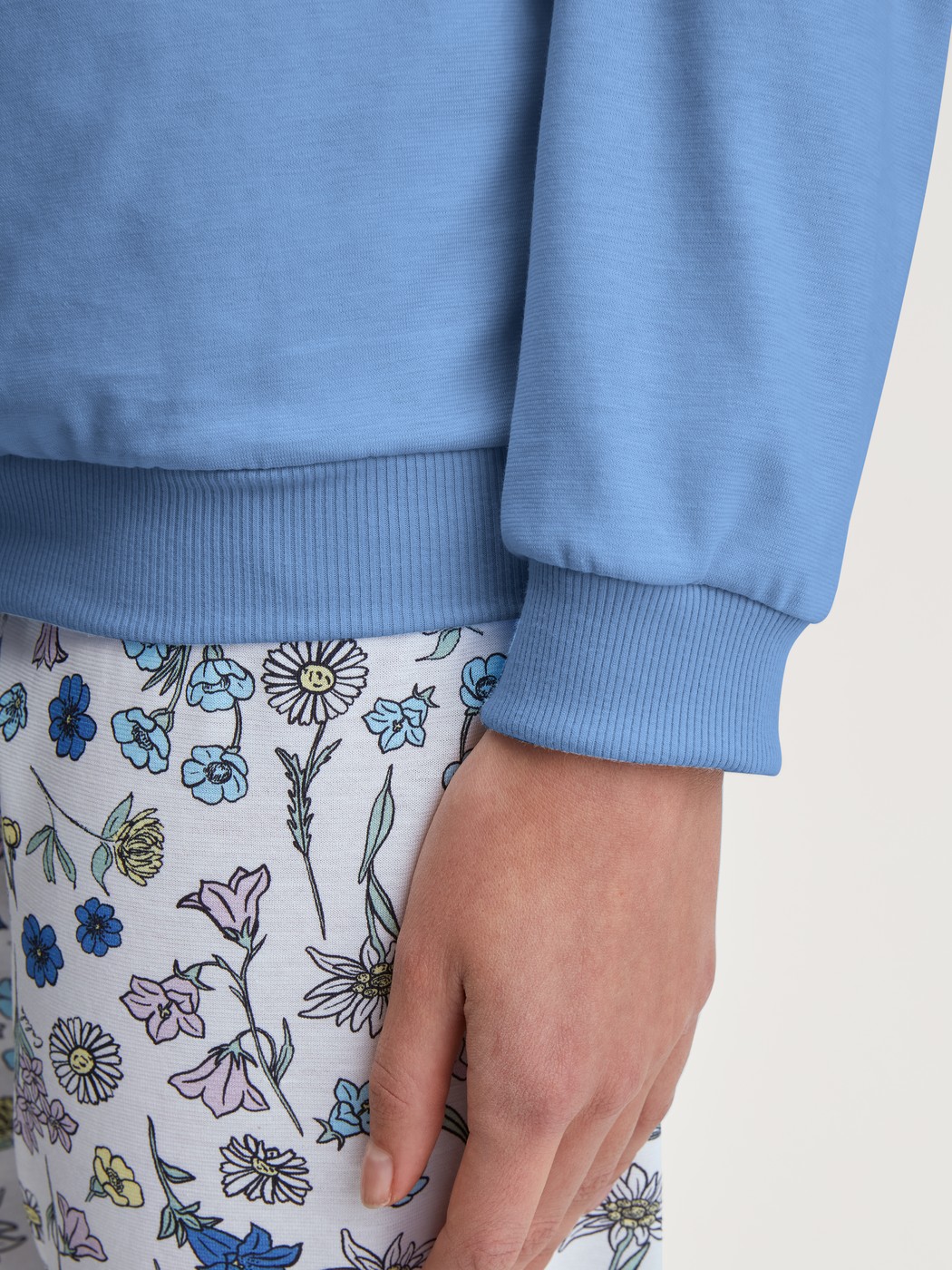 Women model is wearing Pyjama with cuff made of 100% Cotton in Blue, Floral from the Flower Nights series by CALIDA, Detail