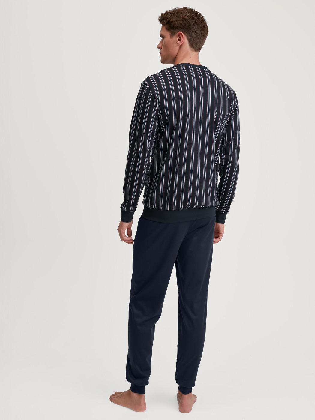 Herren-Model trägt Bündchen-Pyjama aus 100% Baumwolle in Blau, Gestreift aus Serie Relax Streamline 4 von CALIDA, Rückansicht
