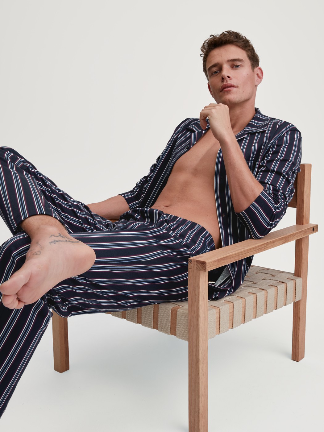 Men model is wearing Button-Up Pyjama made of 100% Cotton in Blue, Striped from the Relax Streamline 4 series by CALIDA, Front view