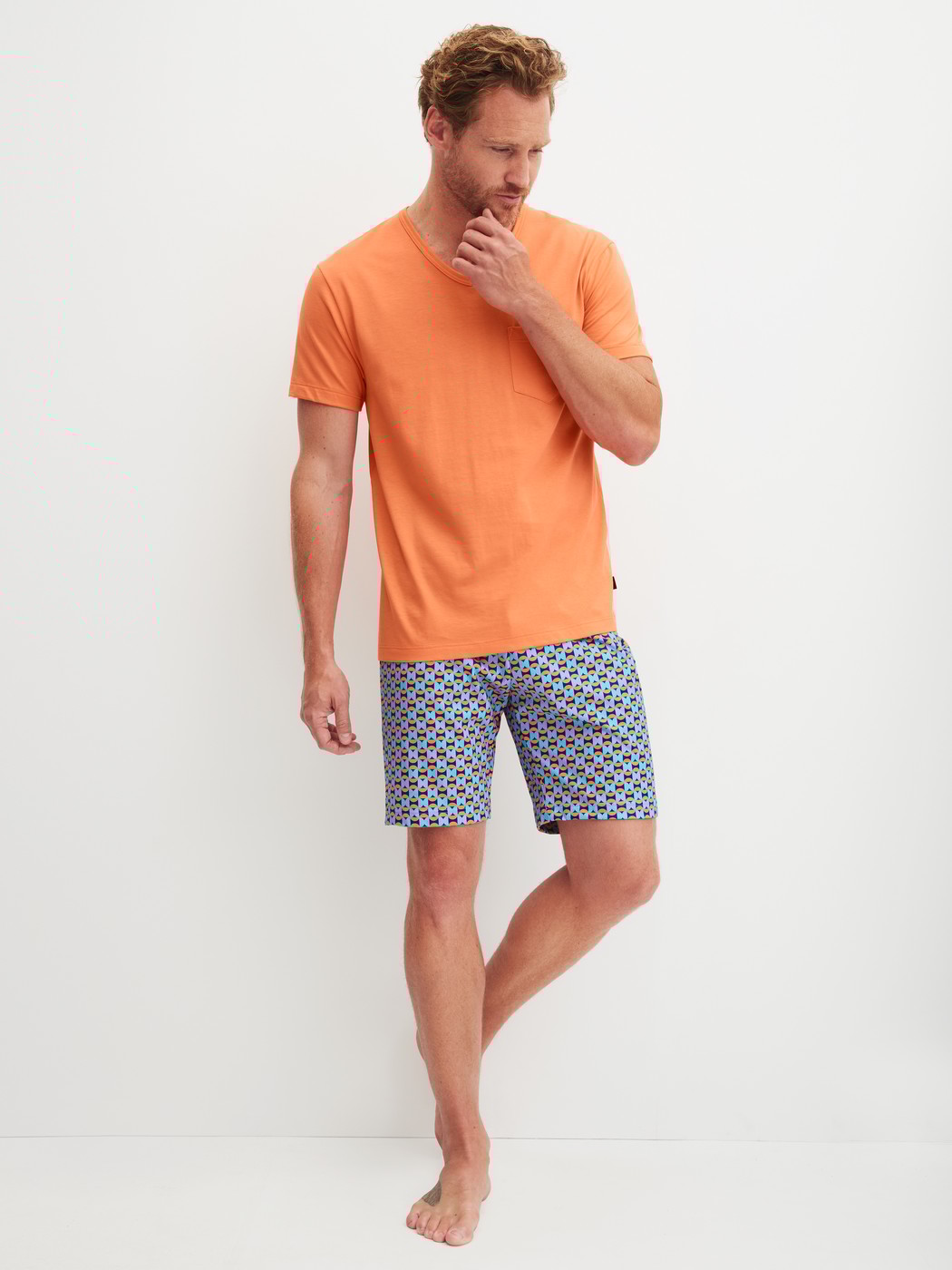 Men model is wearing Short pyjama made of 100% Cotton in Orange, Patterned from the Relax Imprint 4 series by CALIDA, Front view