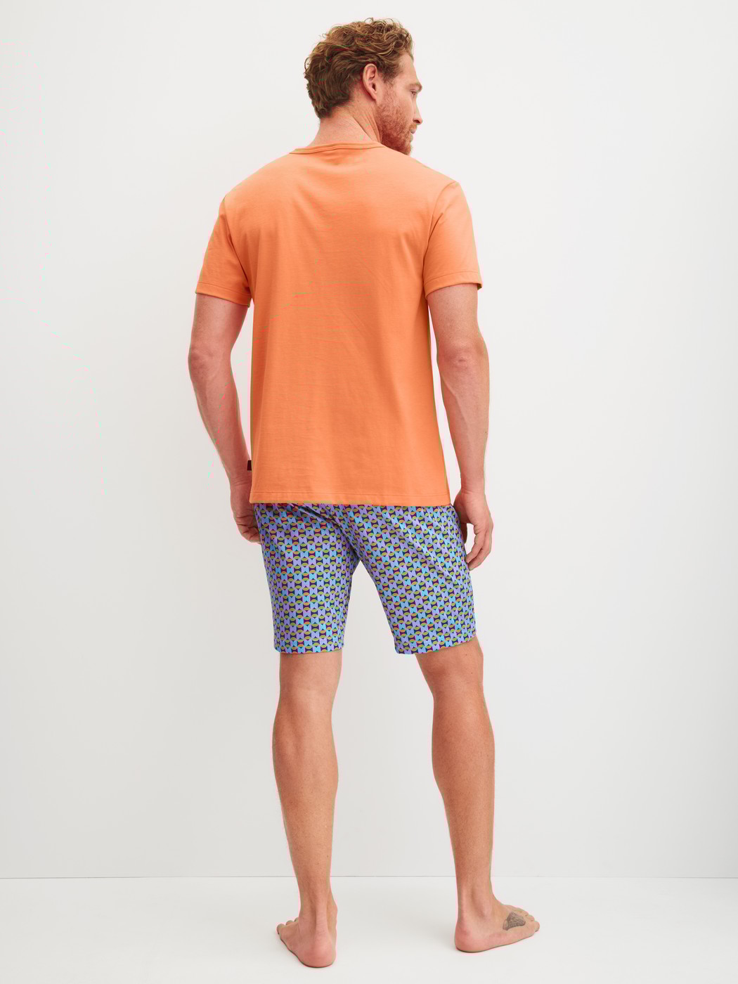Men model is wearing Short pyjama made of 100% Cotton in Orange, Patterned from the Relax Imprint 4 series by CALIDA, Back view