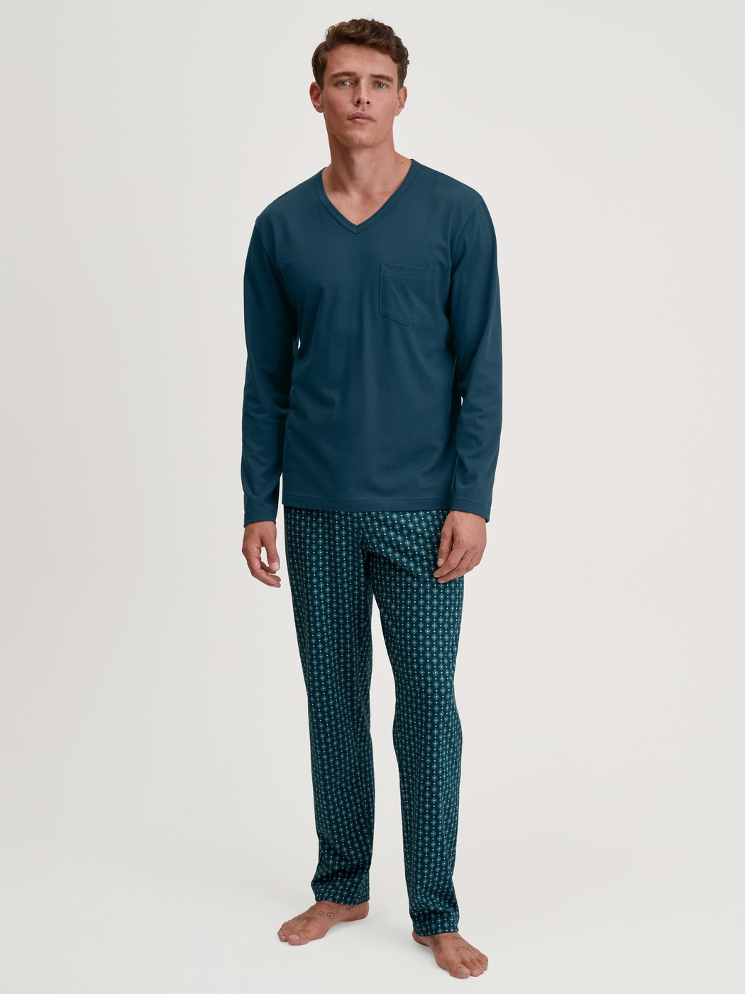 Men model is wearing Pyjamas, long made of 100% Cotton in Turquoise, Patterned from the Relax Imprint 3 series by CALIDA, Front view