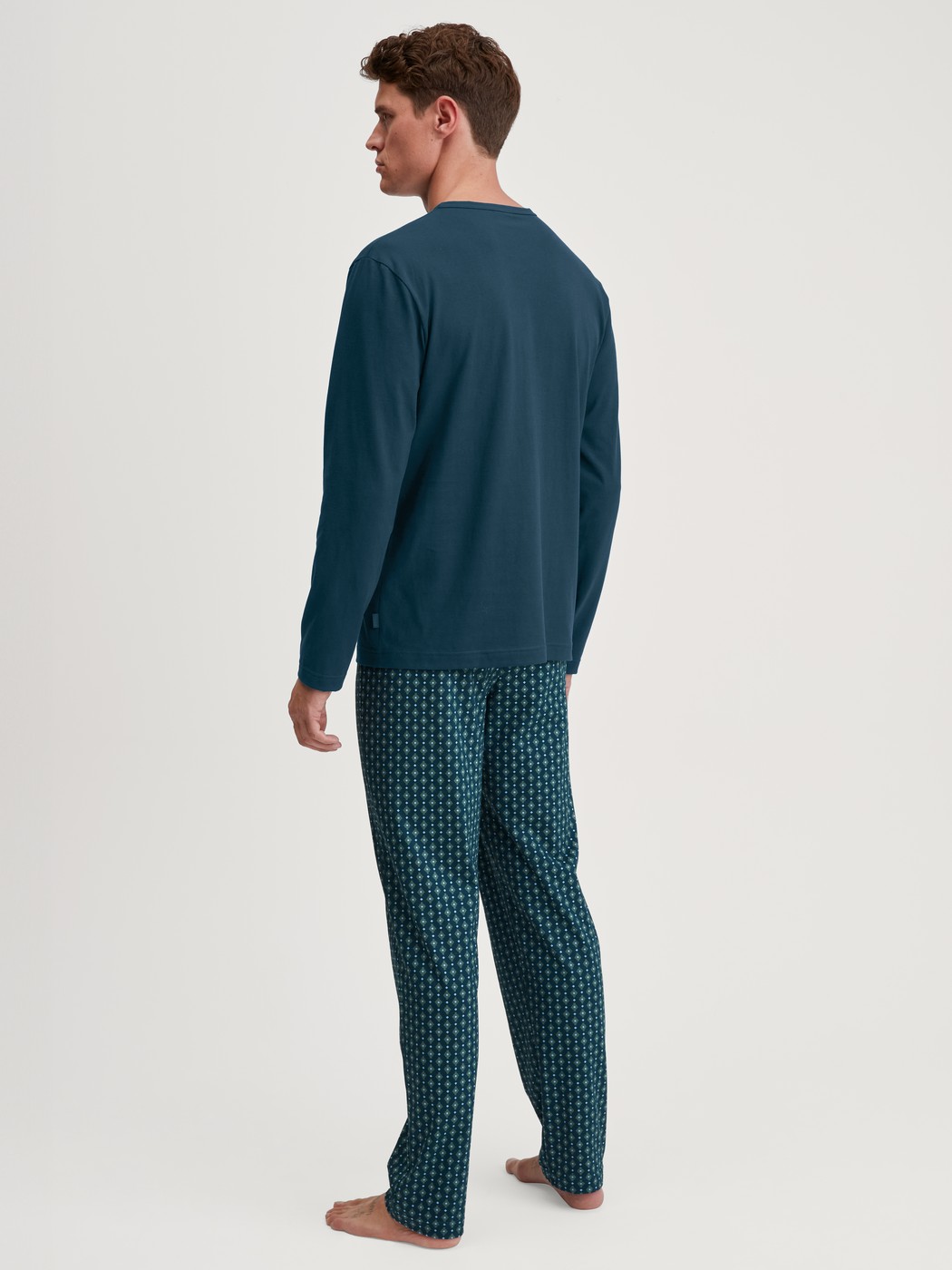 Men model is wearing Pyjamas, long made of 100% Cotton in Turquoise, Patterned from the Relax Imprint 3 series by CALIDA, Back view