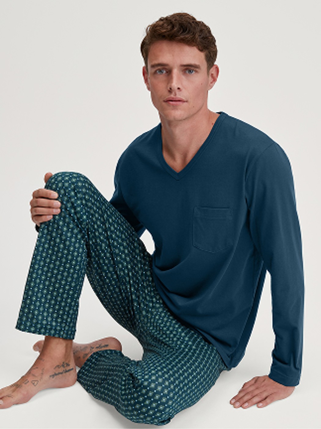 Men model is wearing Pyjamas, long made of 100% Cotton in Turquoise, Patterned from the Relax Imprint 3 series by CALIDA, Front view
