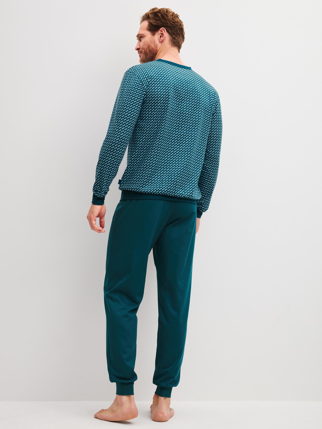 Men model is wearing Pyjama with cuff made of 100% Cotton in Blue, Patterned from the Cotton Special series by CALIDA, Back view
