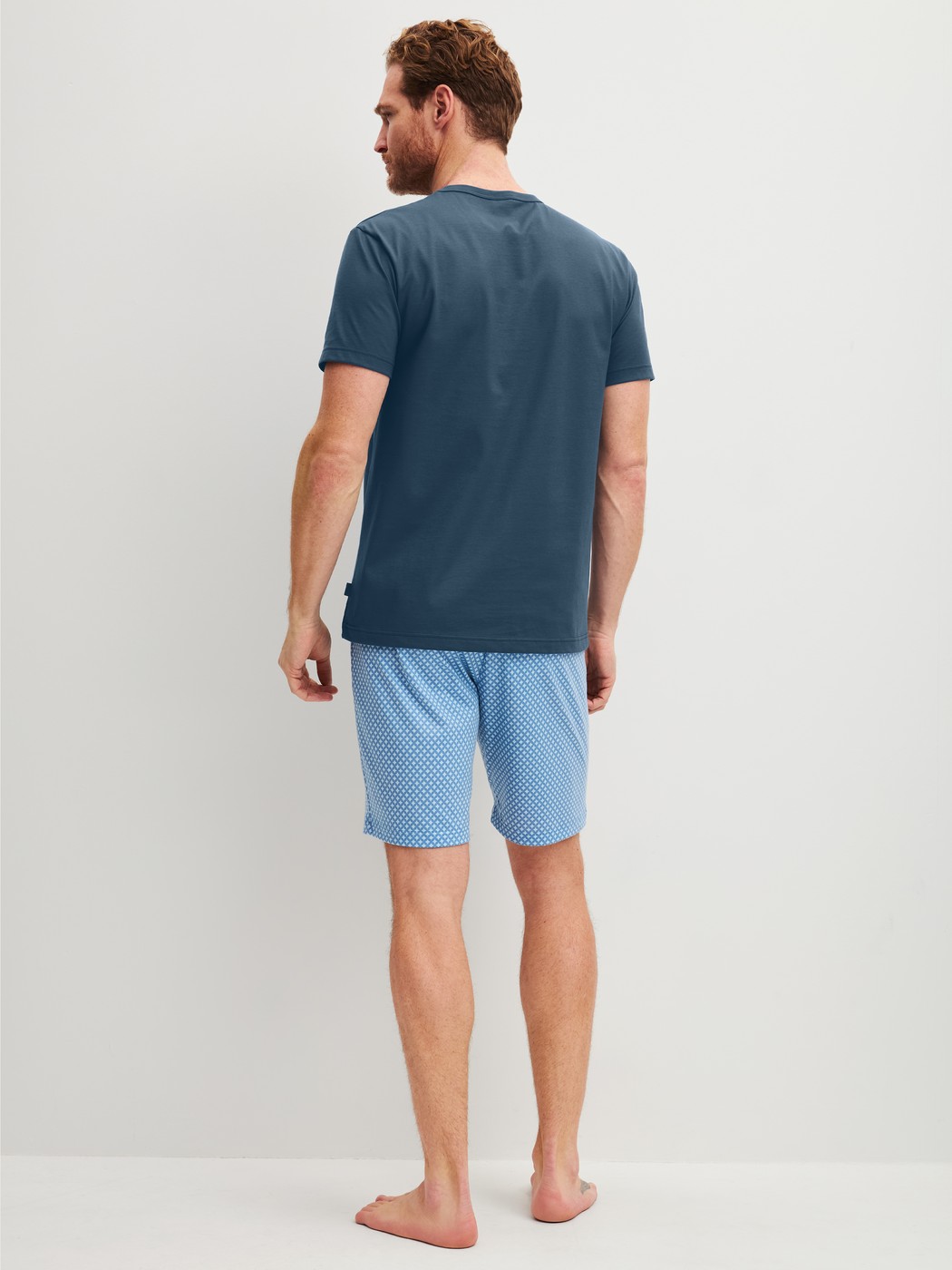 Men model is wearing Short pyjama made of 100% Cotton in Blue, Patterned from the Cotton Special series by CALIDA, Back view