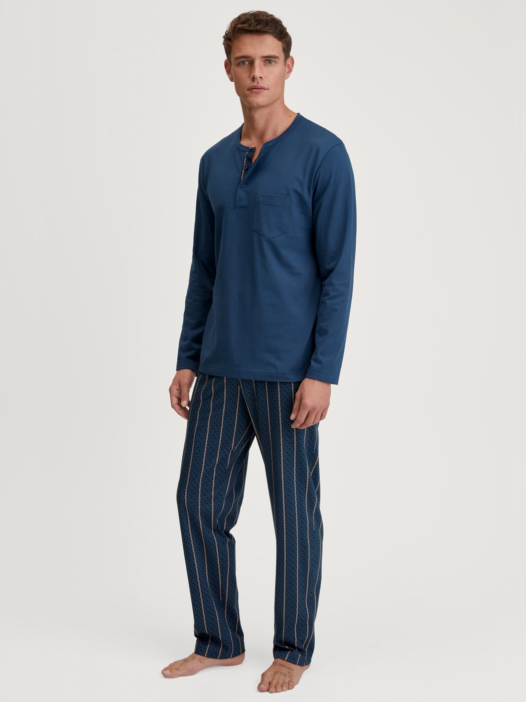 Herren-Model trägt Pyjama, lang aus 100% Baumwolle in Blau, Gestreift aus Serie Relax Imprint 1 von CALIDA, Vorderansicht