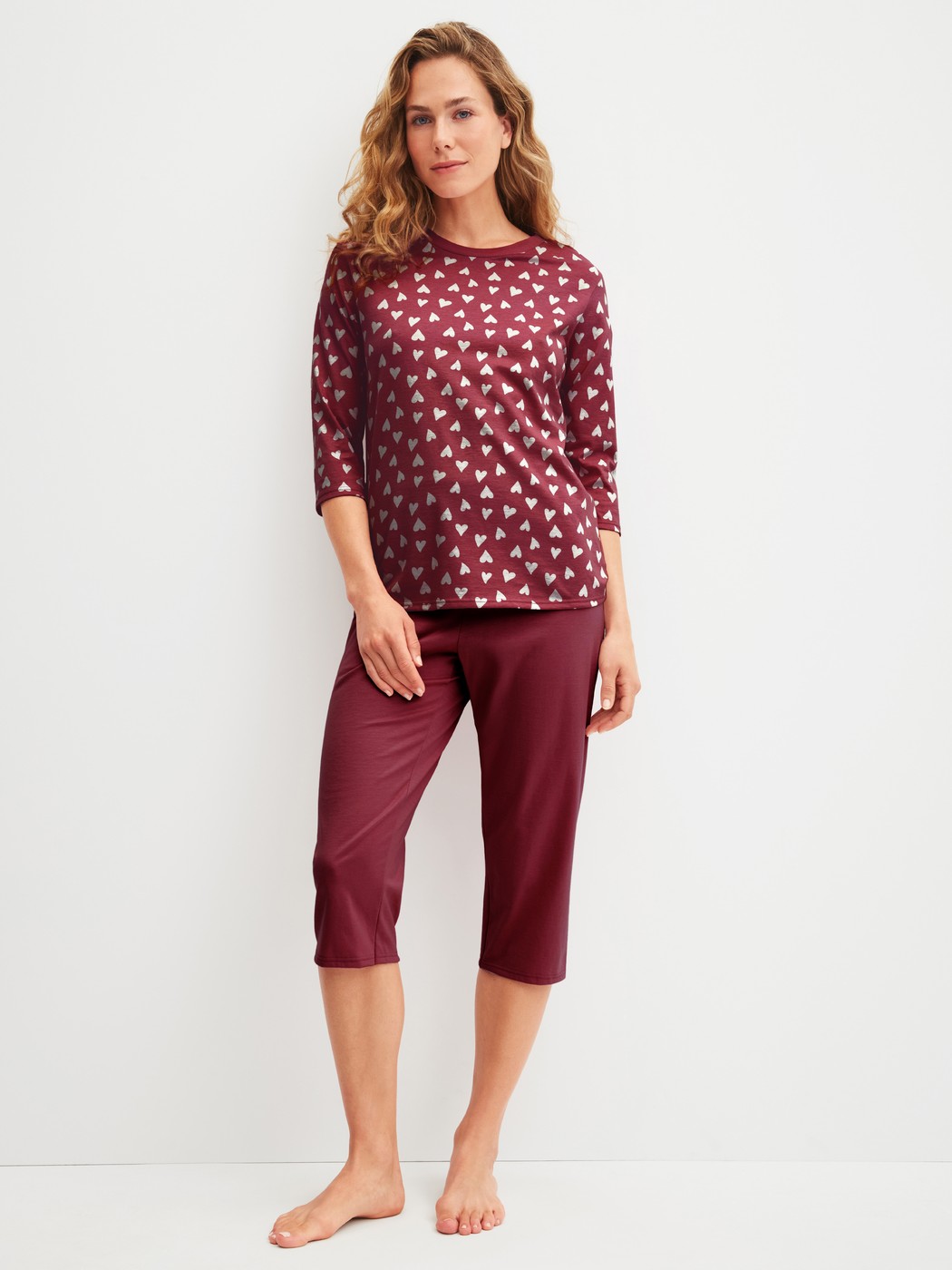 Women model is wearing Capri Pyjama made of 100% Cotton in Red, Patterned from the Cotton Special series by CALIDA, Front view