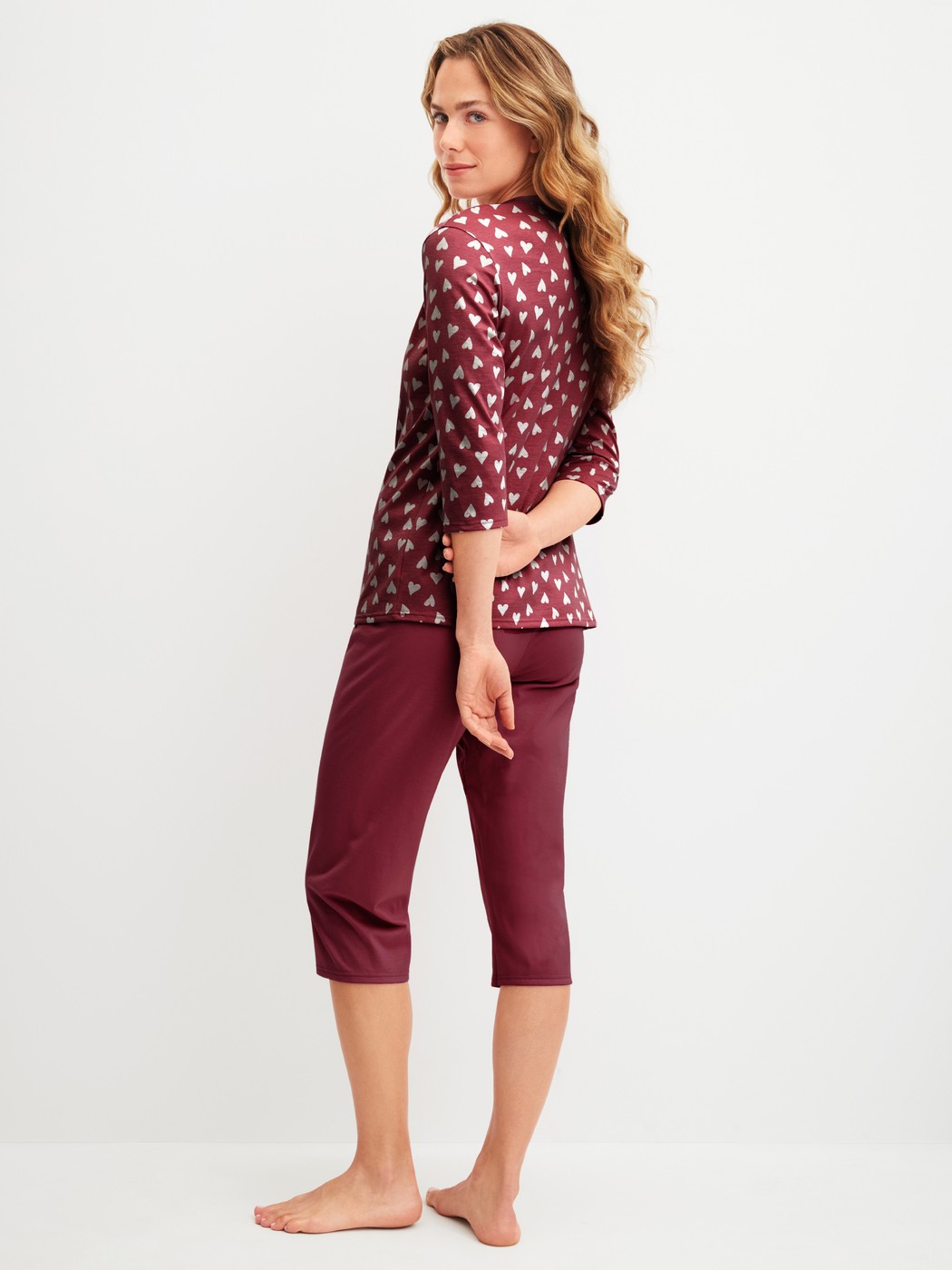 Women model is wearing Capri Pyjama made of 100% Cotton in Red, Patterned from the Cotton Special series by CALIDA, Back view