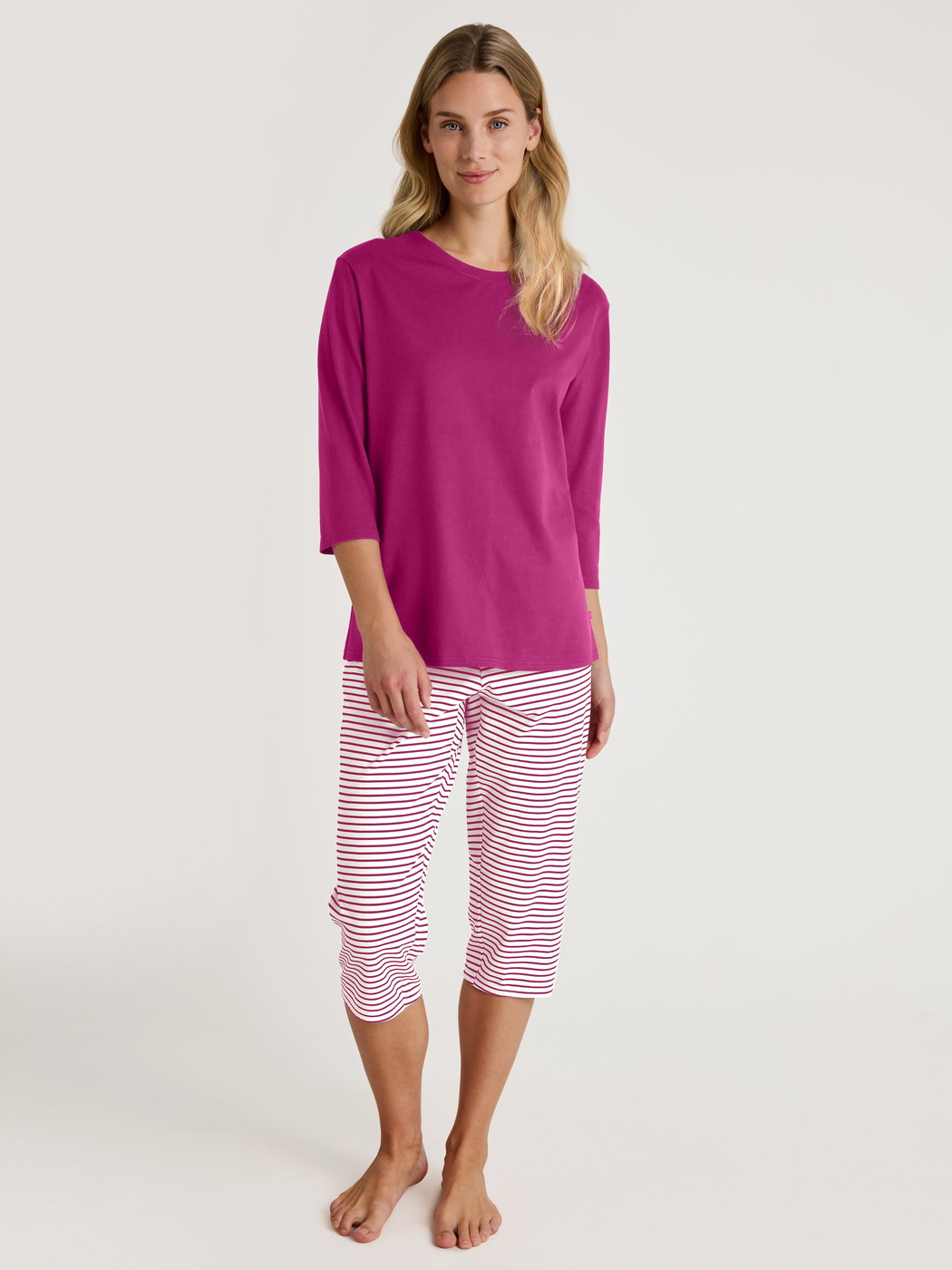 Women model is wearing Capri Pyjama made of 100% Cotton in Red, Striped from the Cotton Special series by CALIDA, Front view