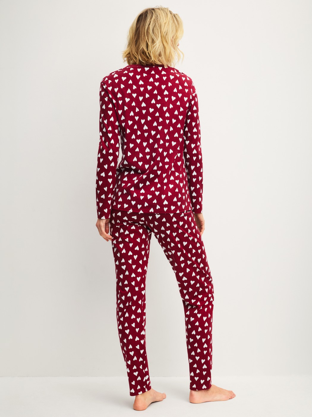 Women model is wearing Pyjamas, long made of 100% Cotton in Red, Patterned from the Cotton Special series by CALIDA, Back view