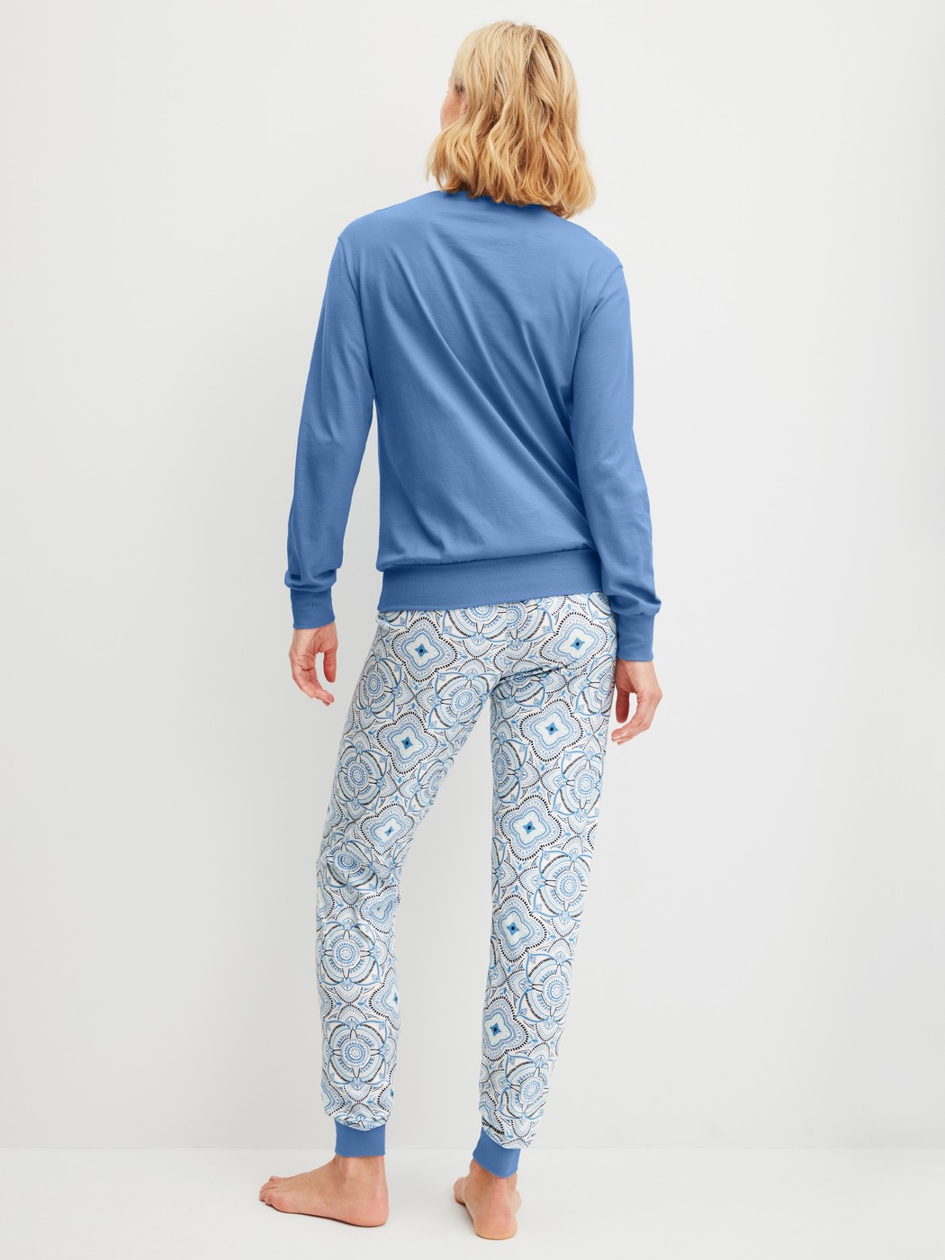 Women model is wearing Pyjama with cuff made of 100% Cotton in Blue, Patterned from the Cotton Special series by CALIDA, Back view