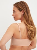 Damen-Model trägt Bustier mit verstellbaren Trägern aus Modal in Rosa, Einfarbig aus Serie Natural Skin von CALIDA, Rückansicht