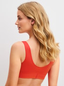 Women model is wearing Bustier made of Cotton in Red, Unicoloured from the Elastic series by CALIDA, Back view
