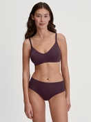 Women model is wearing Bustier with adjustable straps & removable pads made of Modal in Red, Unicoloured from the Natural Skin series by CALIDA, Outfit