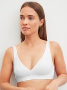 Women model is wearing Soft bra made of Polyamide in White, Unicoloured from the Sleek Skin series by CALIDA, Front view