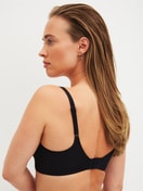 Women model is wearing Bonded Bra made of Modal in Black, Unicoloured from the Natural Skin series by CALIDA, Back view