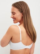 Women model is wearing Padded bra without underwire made of Polyamide in White, Unicoloured from the Sleek Skin series by CALIDA, Back view
