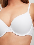 Women model is wearing Moulded Bra with Multiway Straps made of Polyamide in White, Unicoloured from the Sleek Skin series by CALIDA, Detail