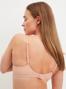 Women model is wearing Moulded Bra with Multiway Straps made of Polyamide in Beige, Unicoloured from the Sleek Skin series by CALIDA, Back view