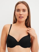 Women model is wearing Moulded Bra with Multiway Straps made of Polyamide in Black, Unicoloured from the Sleek Skin series by CALIDA, Front view