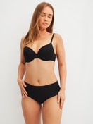 Women model is wearing Moulded Bra with Multiway Straps made of Polyamide in Black, Unicoloured from the Sleek Skin series by CALIDA, Outfit