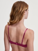 Underwired T-shirt bra Women model is wearing Underwired T-shirt bra made of 100% Cotton in Pink, Unicoloured from the Cate series by CALIDA, Back view