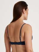Women model is wearing Underwired T-shirt bra with padding made of Viscose in Blue, Lace from the Sensual Secrets series by CALIDA, Back view