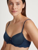 Women model is wearing Underwired T-shirt bra with padding made of Viscose in Blue, Lace from the Sensual Secrets series by CALIDA, Detail