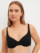 Women model is wearing underwired bra made of Polyamide in Black, Unicoloured from the Sleek Skin series by CALIDA, Front view