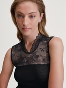 Women model is wearing Tank top made from wool and silk made of Lace in Black, Lace from the Silky Wool Glam series by CALIDA, Detail