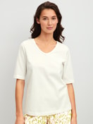 Women model is wearing Short-sleeved shirt with V-neck made of 100% Cotton in White, Unicoloured from the Late Bloom M&M series by CALIDA, Front view