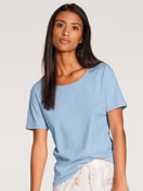 Women model is wearing Shirt short sleeve made of 100% Cotton in Blue, Unicoloured from the Favourites Sunflower series by CALIDA, Front view