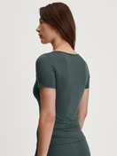 Women model is wearing Shirt shortsleeve made of Cotton in Green, Unicoloured from the Natural Comfort series by CALIDA, Back view