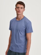 Men model is wearing Short-sleeved shirt made of 100% Cotton in Blue, Unicoloured from the Remix Basic Sleep series by CALIDA, Front view